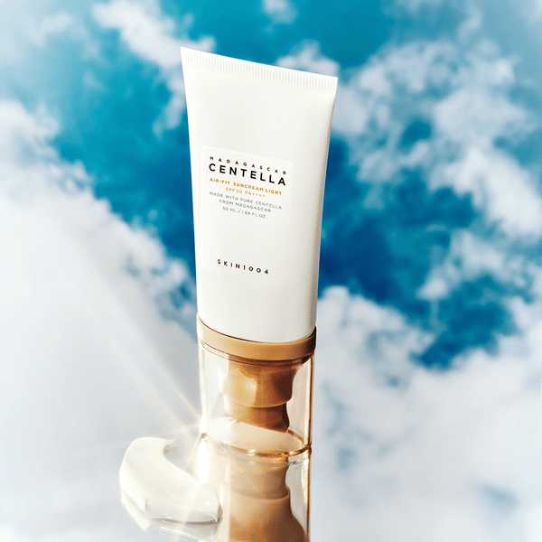 A pump bottle of Centella Air - Fit 30+ Sunscreen Light SPF30 against a cloudy sky background.