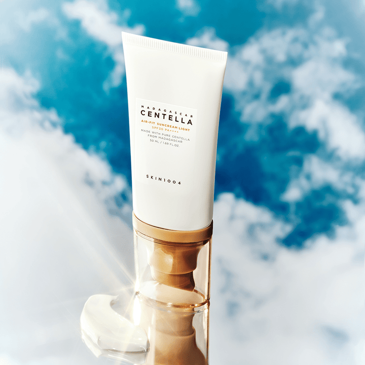 A pump bottle of Centella Air - Fit 30+ Sunscreen Light SPF30 against a cloudy sky background.