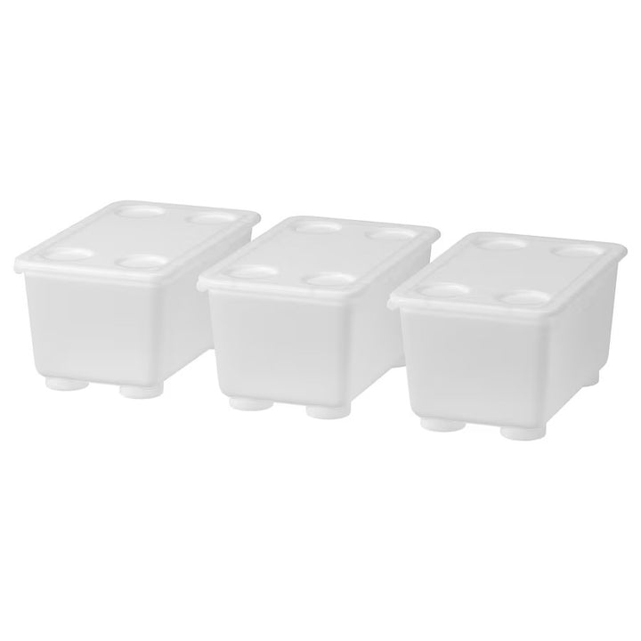 Three white, stackable plastic storage boxes with lids.