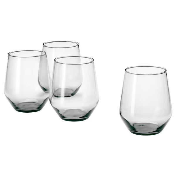 A set of four clear glass stemless wine glasses arranged on a neutral background.