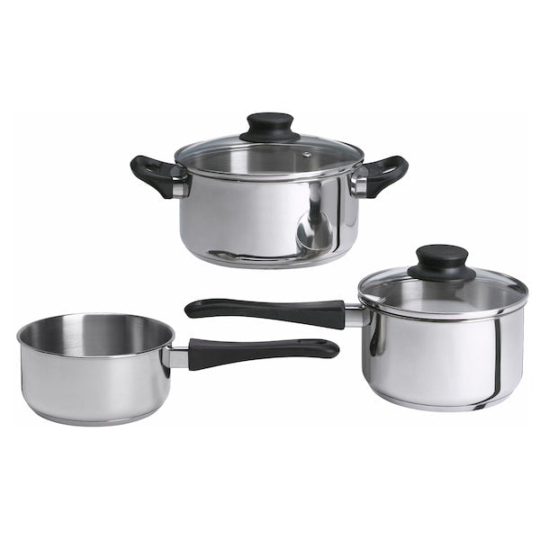 A set of stainless steel cookware with glass lids and black handles, including a small saucepan, a medium saucepan, and a larger pot.