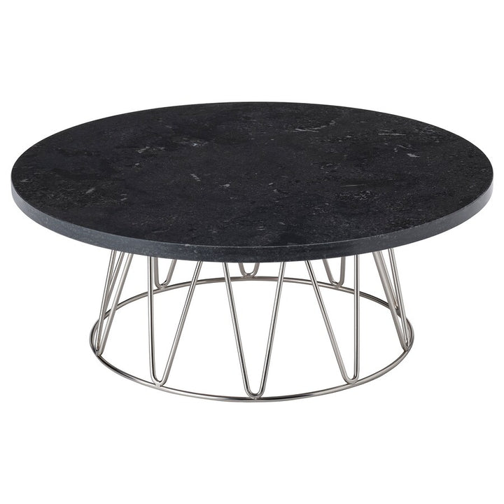 A cake stand with a black marble top and a stainless steel wire base.