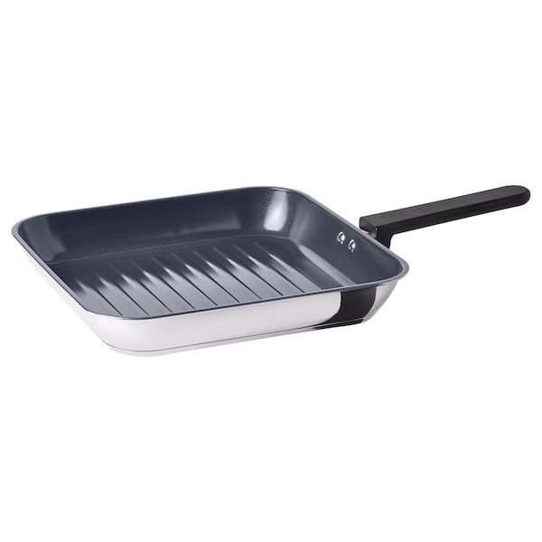 A silver MIDDAGSMAT grill pan with a black handle, featuring a ridged cooking surface and a flat handle.