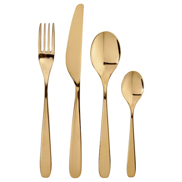 A set of brass-colored flatware, including a fork, knife, spoon, and possibly a teaspoons, against a white background.